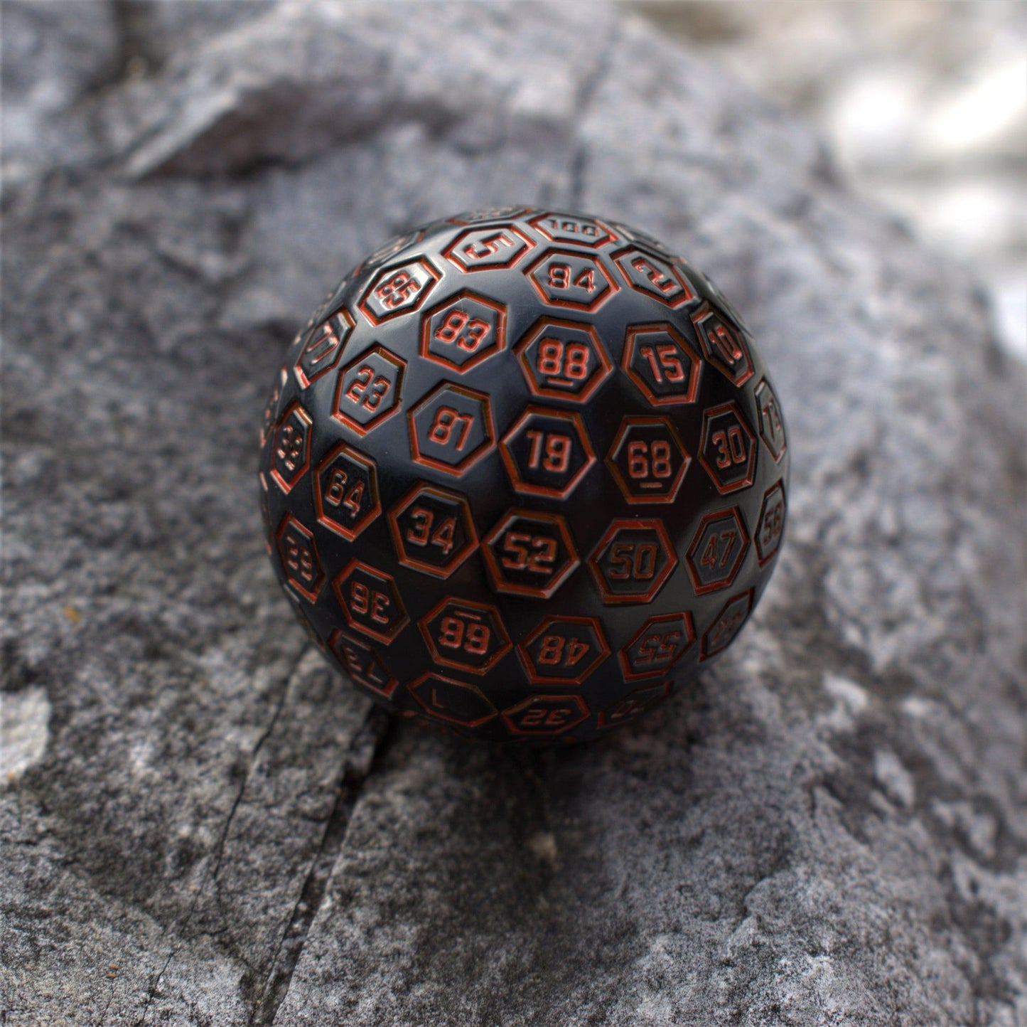 The Orb D100 - Black and Orange Metal Die